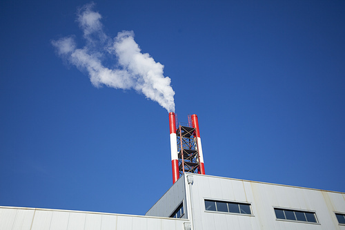 Heating plant - powerhouse and chimey with smoke make heat energy for city in winter