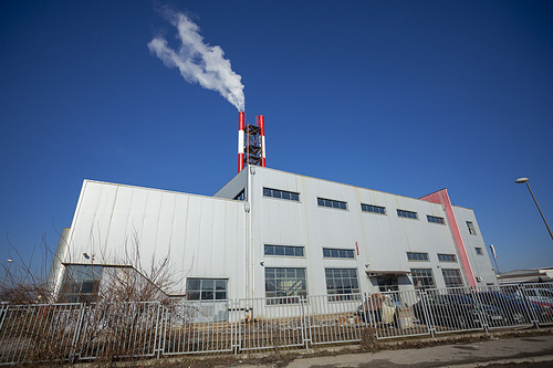 Heating plant - powerhouse and chimey with smoke make heat energy for city in winter