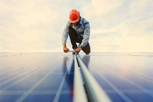 The young man is repairing the solar panel at the station.