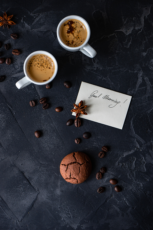 Cup of coffee and good morning note on wooden background with copy space