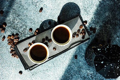 Two mags of americano coffee as a morning concept on stone background with copy space