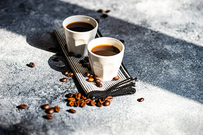 Two mags of americano coffee as a morning concept on stone background with copy space