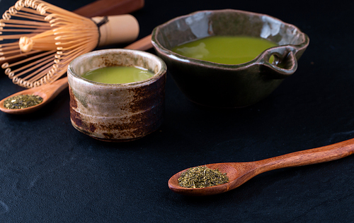 green tea matcha in a bowl on wooden surface