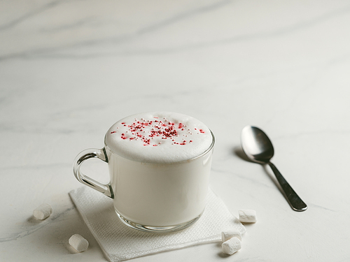Babyccino - whipped milk or cream and candy sprinkles. Drink for kids idea and recipe - babyccino is warm whipped milk, without coffee, without sugar. Copy space for text
