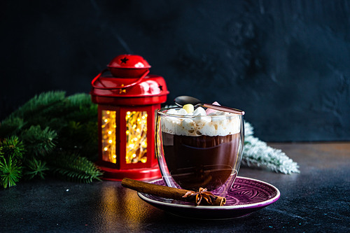 Glass with christmas cocoa drink with marshmallow on stone background with copy space
