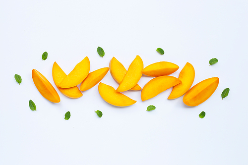 Tropical fruit, Mango slices with mint leaves on white background. Top view