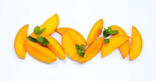 Tropical fruit, Mango slices with mint leaves  on white background. Top view