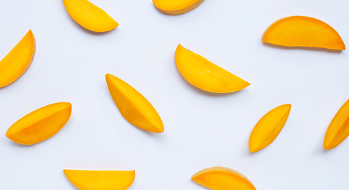 Mango slices on white background. Top view of tropical fruit