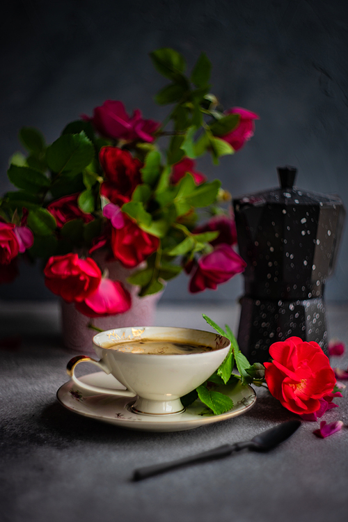 Coffee set with red roses and coffee pot on concrete background with copy space