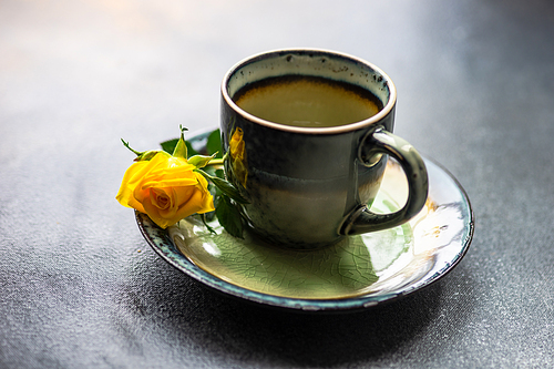 Fresh yellow roses after the rain in a coffee mug on rustic background with copy space