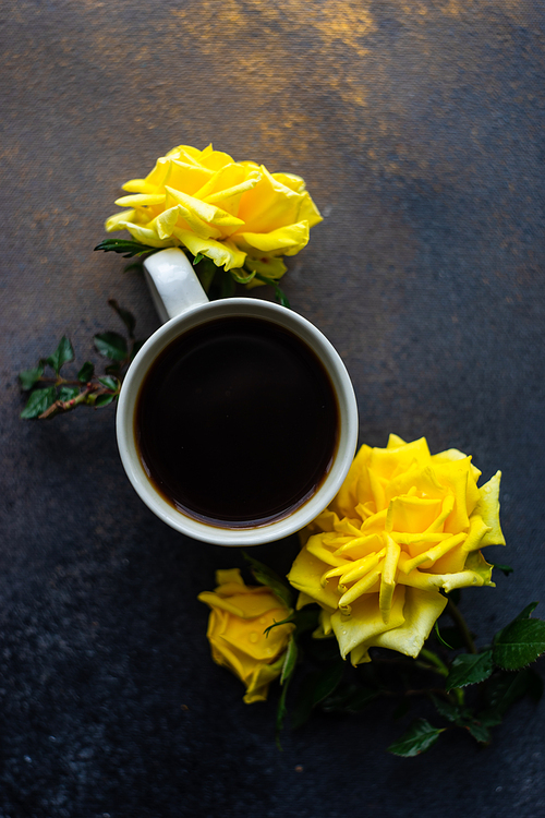 Cup of coffee and fresh yellow roses on rustic background with copy space