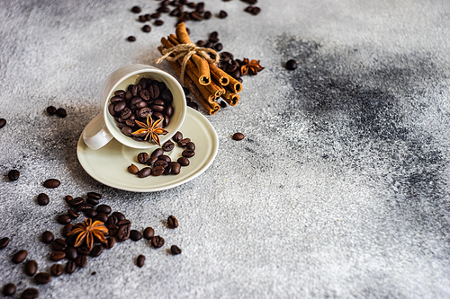 Ceramic cup and coffee beans on stone background with copy space as a coffee concept