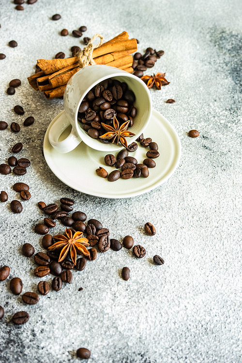 Ceramic cup and coffee beans on stone background with copy space as a coffee concept