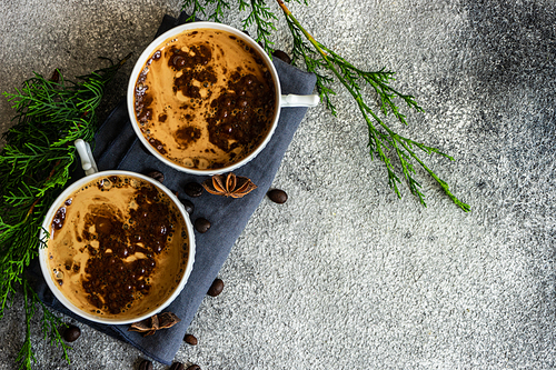 Cup of coffee and Christmas decor on rusty stone backgtound  with copy space