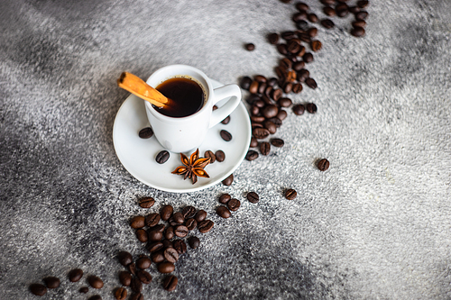 Cup of morning coffee with cinnamon stics and anise star as a drink concept with copy space