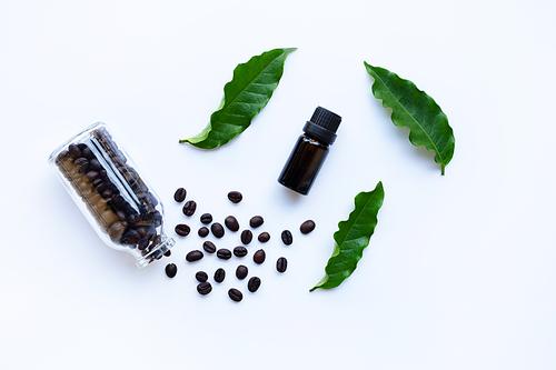 Glass bottle with essential oil of coffee on white background