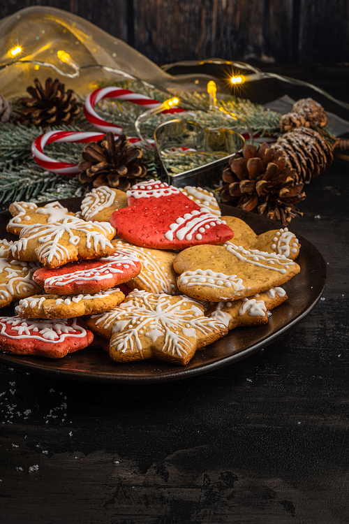 Baked Christmas cookies on rustic dark background.