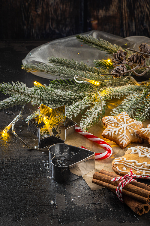 Baked Christmas cookies on rustic dark background.