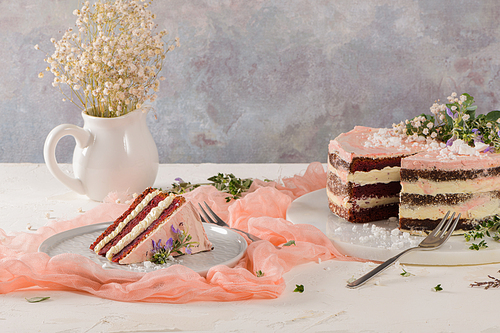 Slice of strawberry cake, strawberry sponge cake with fresh strawberries and sour cream on a pink background.