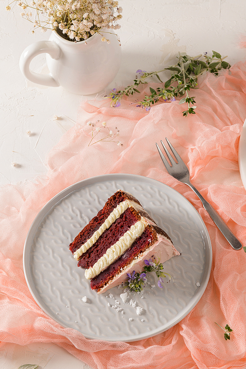 Slice of strawberry cake, strawberry sponge cake with fresh strawberries and sour cream on a pink background.