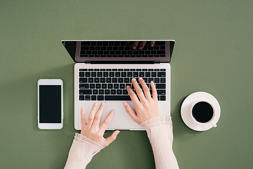 stylish young girl working analytics typing on laptop and papers flat lay