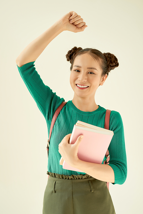 Young smiling beautiful woman with hands up, pleased with the success or luck.