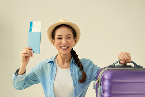 Traveler tourist woman in summer casual clothes, hat with suitcase isolated on light background.