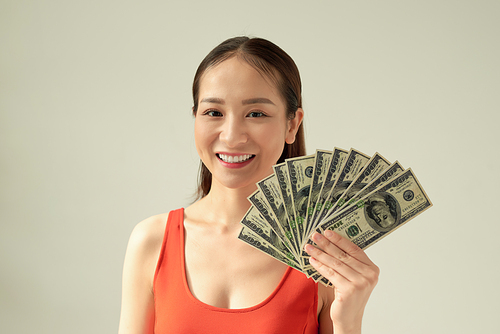 Young asian woman holding money