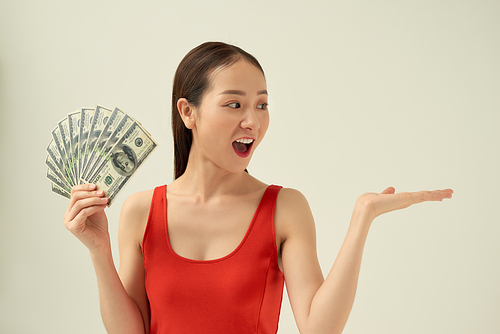 Photo of rich woman in basic clothing holding fan of dollar money isolated over light background