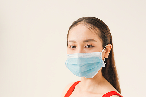Young Asian woman wearing a mask to prevent germs, toxic fumes, and dust. Prevention of bacterial infection in the air in a white background