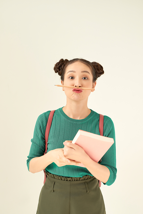education, school, inspiration and people concept - young woman or teenage student girl in green t-shirt with 다이어리 or notebook and pencil-mustache over bright green background
