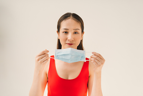 Young Asian woman wearing a mask to prevent germs, toxic fumes, and dust. Prevention of bacterial infection in the air in a white background