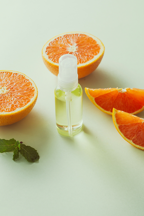 Tangerine oil on table on light background