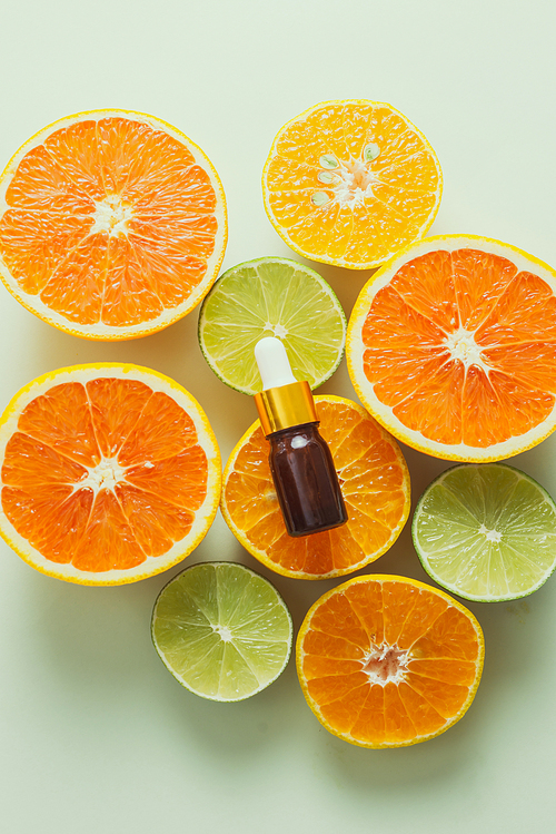 Brown Bottle with lemon, orange, tangerine and vitamin C. on white background.