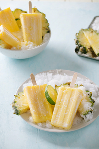 Some homemade Pineapple Popsicles (selective focus) on a rustic background