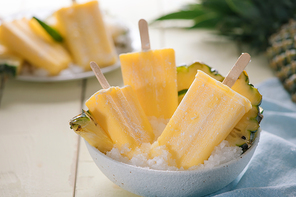 Homemade ice cream or popsicles from pineapple decorated. Top view. Frozen fruit pulp. Summer sweets