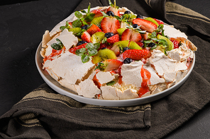 Pavlova cake with fresh blueberries, strawberries and kiwi.