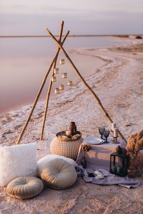 moroccan decor on the shores of a beautiful lake, candles and bungalows