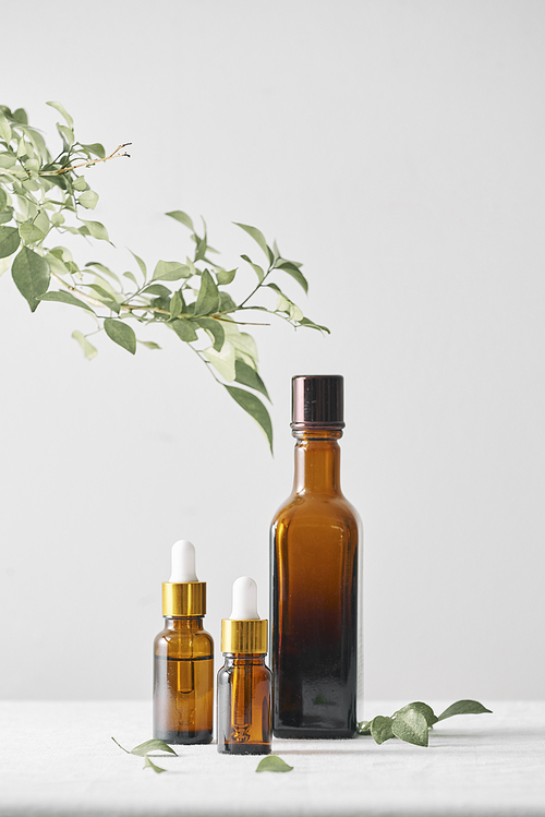 Bottles with aroma oil, medicines on wooden background. Selective focus,horizontal.