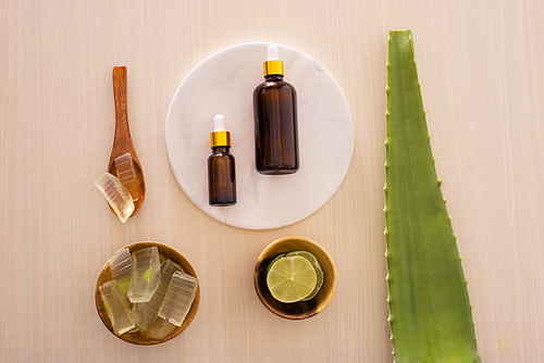 bottle of aloe vera essential oil with peeled aloe - beauty treatment
