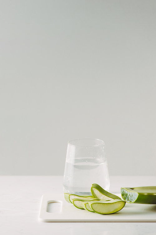 Fresh aloe vera leaves and glass of aloe vera juice healthy drink isolated on white