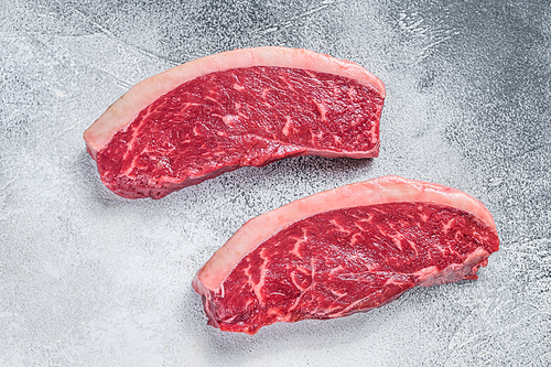 Raw cap rump or top sirloin beef meat steak. White background. Top view.