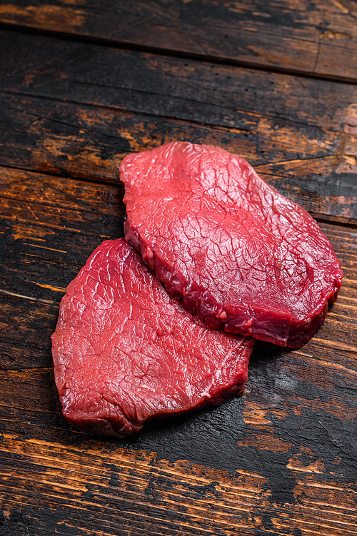 Raw black angus beef meat sirloin steak. Dark wooden background. Top view.