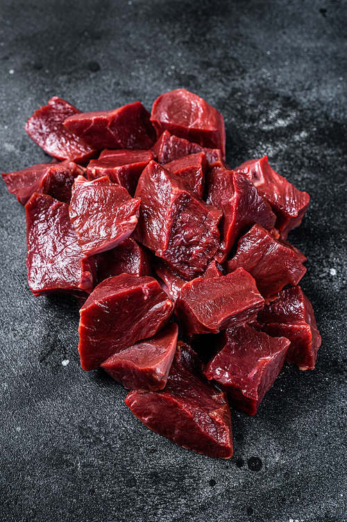 Raw sliced Beef or veal heart. Black background. Top View.