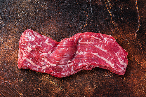 Raw machete skirt beef steak on butcher table. Dark background. Top view.