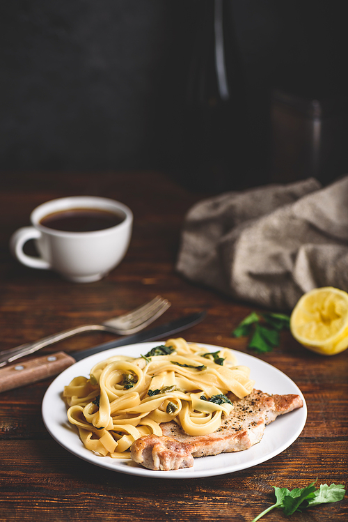 Pork chop steak and tagliatelle with capers and lemon zest