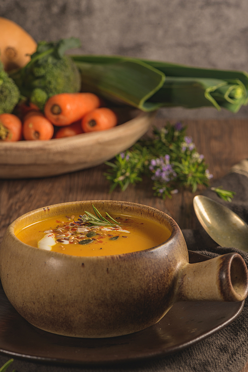 Healthy Pumpkin soup with cream and organic pumpkin seeds.