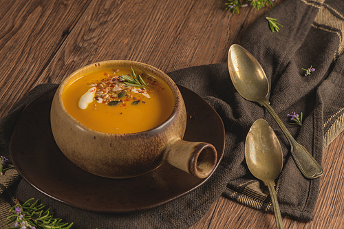 Healthy Pumpkin soup with cream and organic pumpkin seeds.