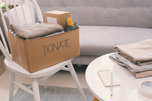 Donation box and casual clothes in livingroom