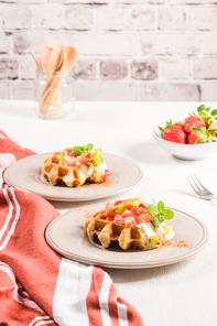 Fresh egg waffles dessert for breakfast with yogurt, strawberries and kiwi.